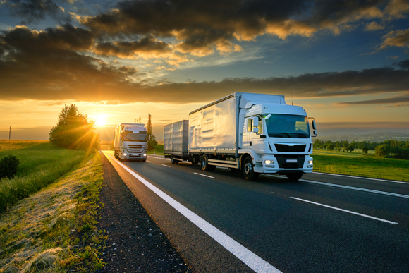 Trucks On An Asphalt Road — Equipment Hire in Rockhampton, QLD
